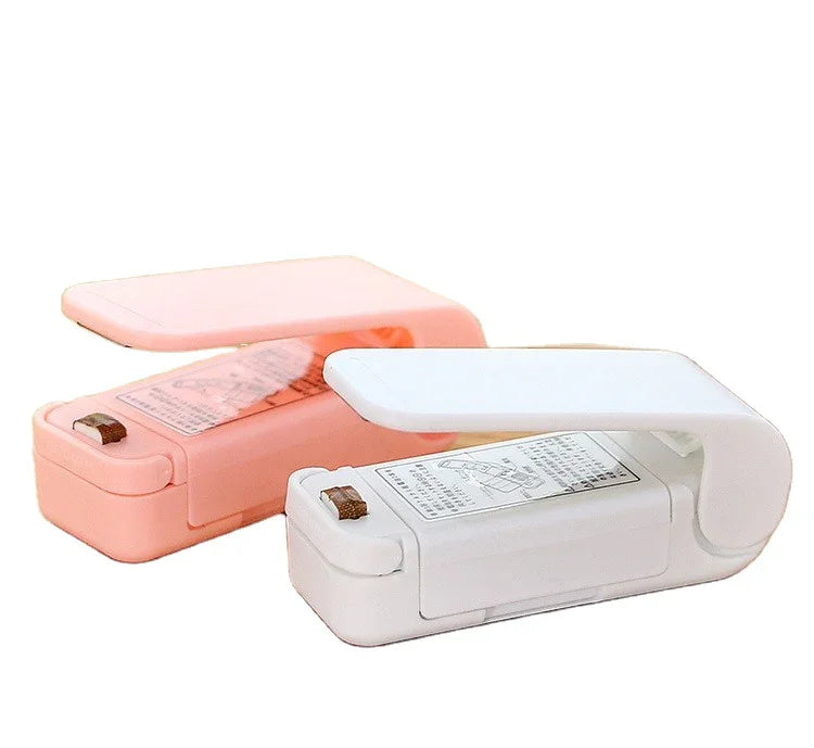 Two electronic devices, one pink and one white, on a white background